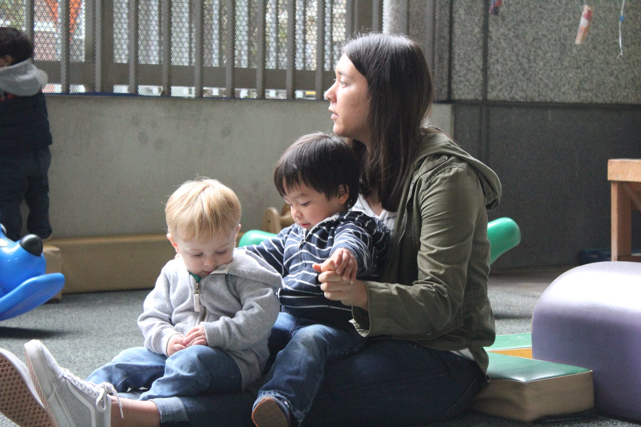 Early educator sitting with two children