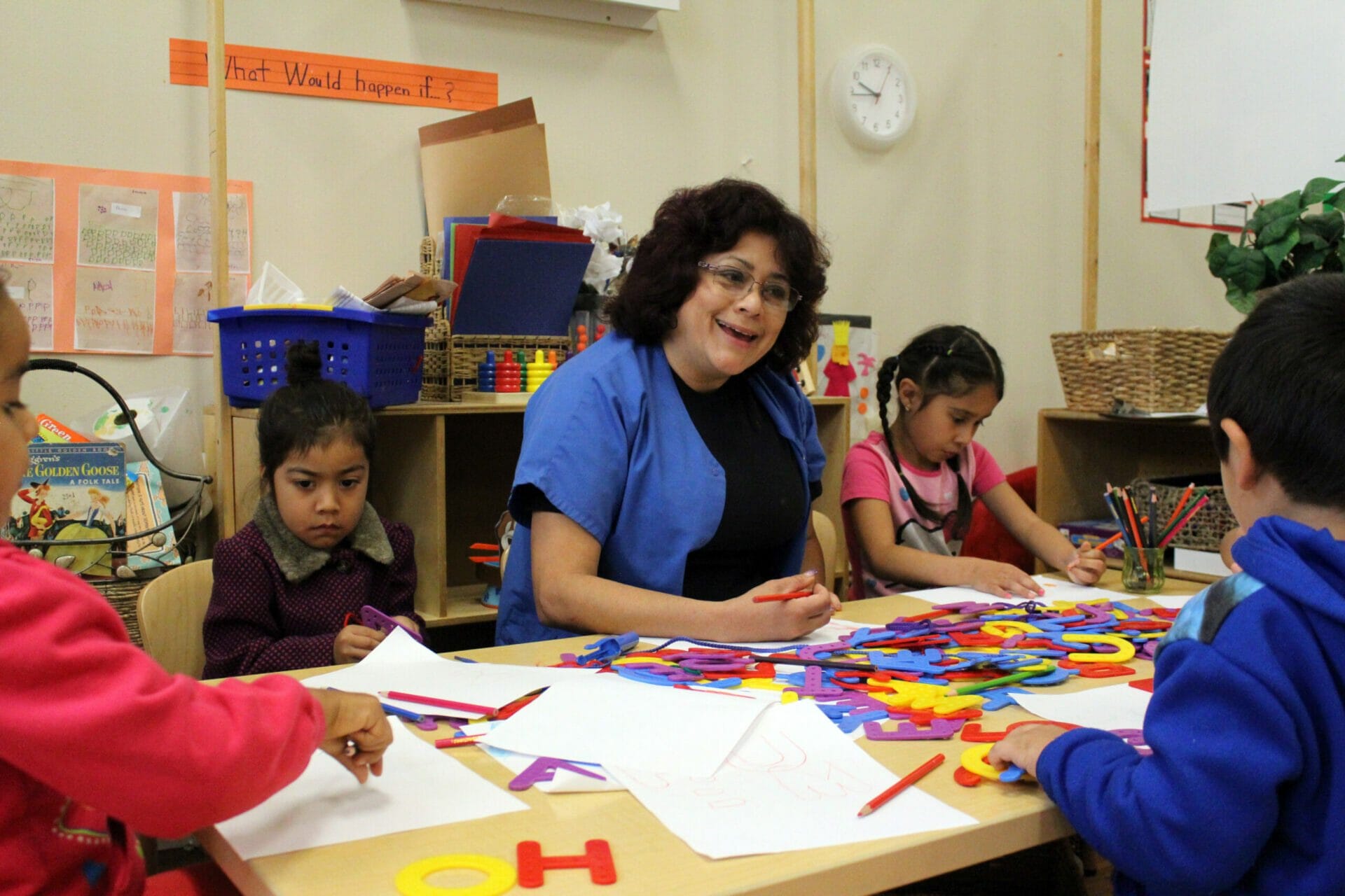 An early educator helping children with their activity.