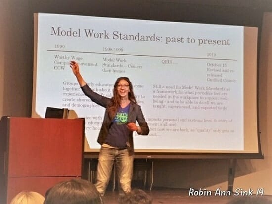 Woman giving a presentation on the model work standards.