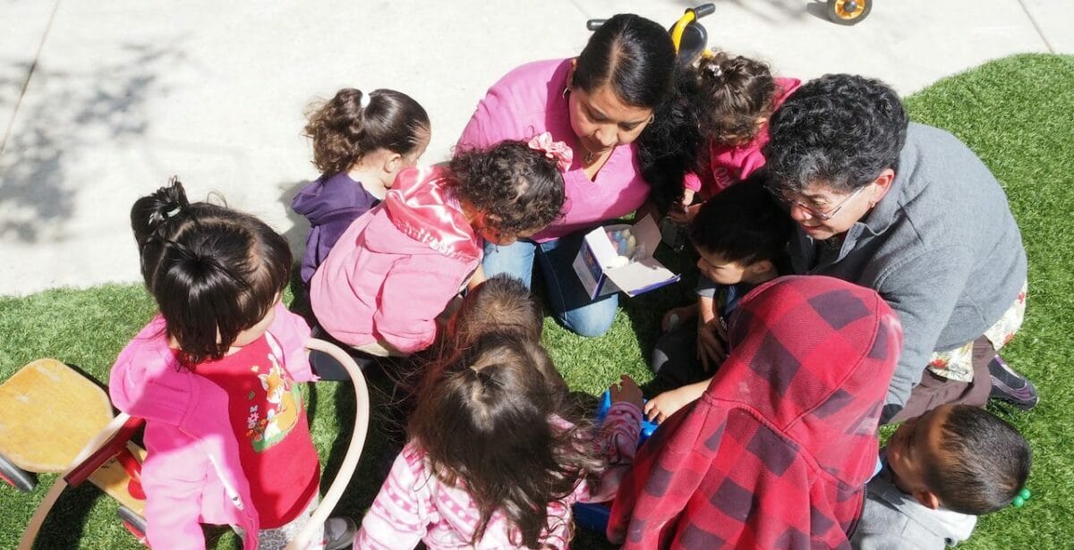 Child educator surrounded by children for an activity