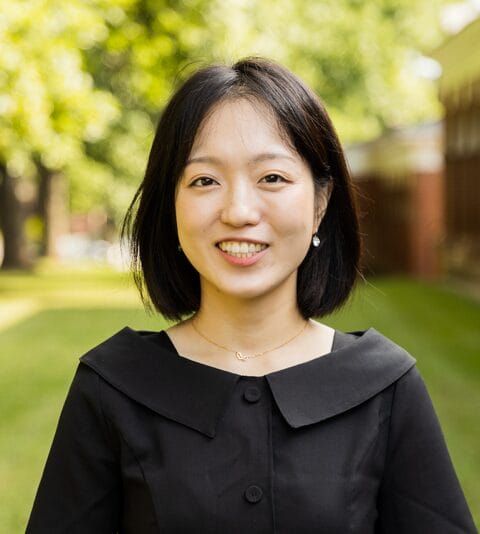 One of our staff members smiling for a headshot, Hyeonjeong Lee.
